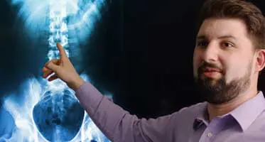 Dr. Ben Wyant, InMotion Pain Solutions, reviewing an x-ray.